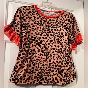 Blue Buttercup leopard print with red collar and sleeves…unique soft top